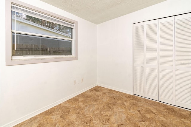 unfurnished bedroom with a closet and a textured ceiling