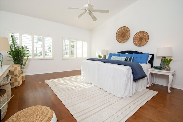 bedroom featuring ceiling fan, dark hardwood / wood-style flooring, and lofted ceiling