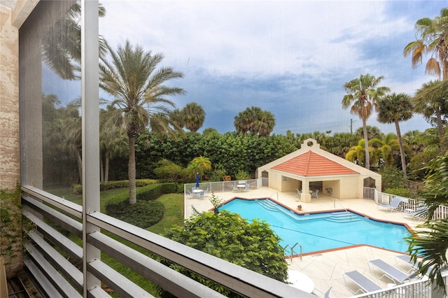 view of swimming pool with a patio area and an outbuilding