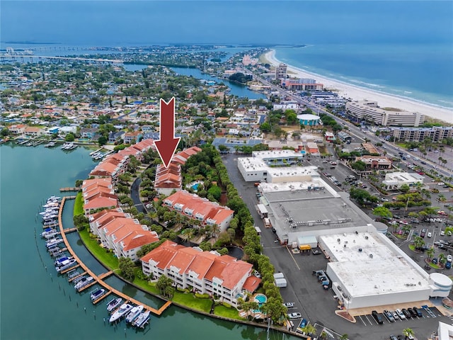 birds eye view of property with a water view and a beach view