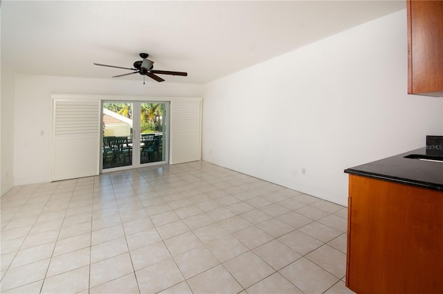 interior space with ceiling fan and light tile patterned floors