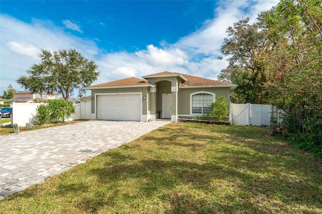 mediterranean / spanish-style home featuring a garage and a front yard