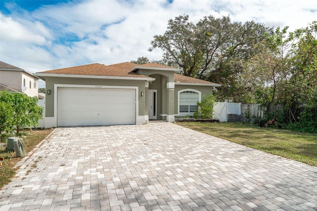 view of front facade featuring a garage and a front lawn