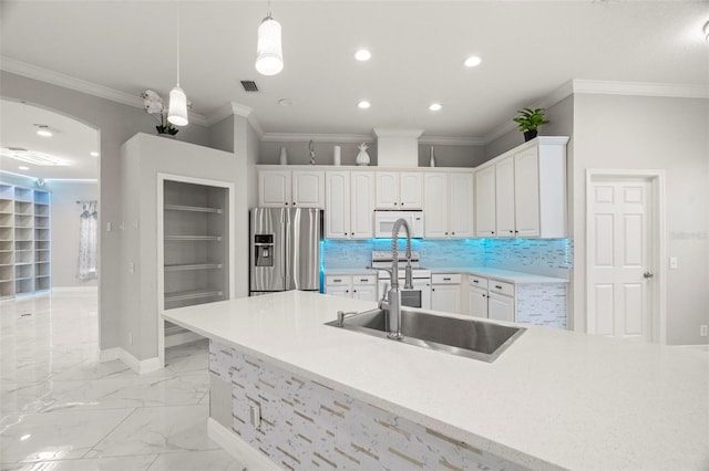 kitchen featuring built in shelves, white cabinetry, pendant lighting, and appliances with stainless steel finishes