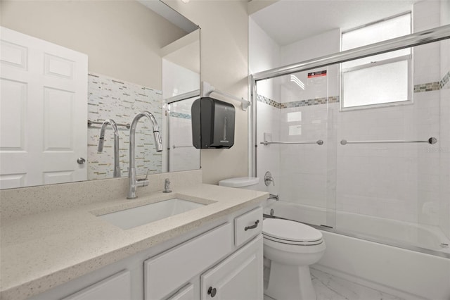 full bathroom featuring enclosed tub / shower combo, vanity, and toilet