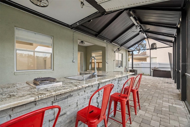 view of patio / terrace featuring an outdoor wet bar