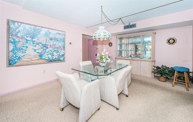 dining room featuring a textured ceiling