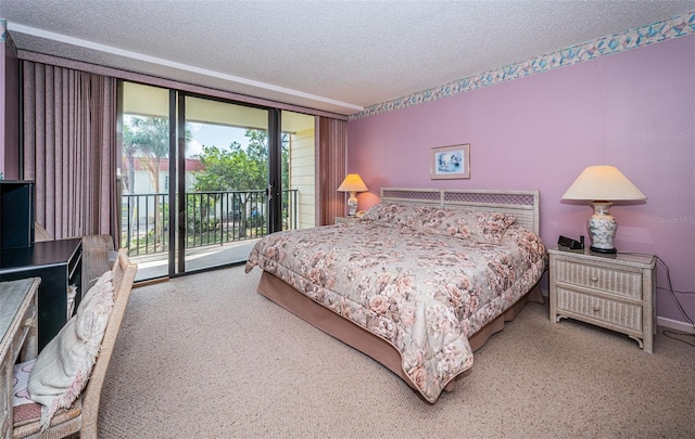 carpeted bedroom with access to outside and a textured ceiling