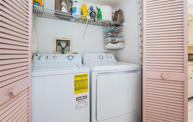 laundry room featuring washer and clothes dryer and a textured ceiling