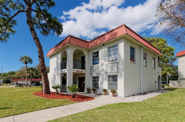 exterior space featuring a front yard and a balcony