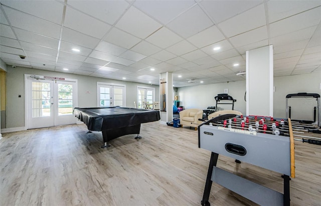 game room with a drop ceiling, light wood-type flooring, pool table, and french doors