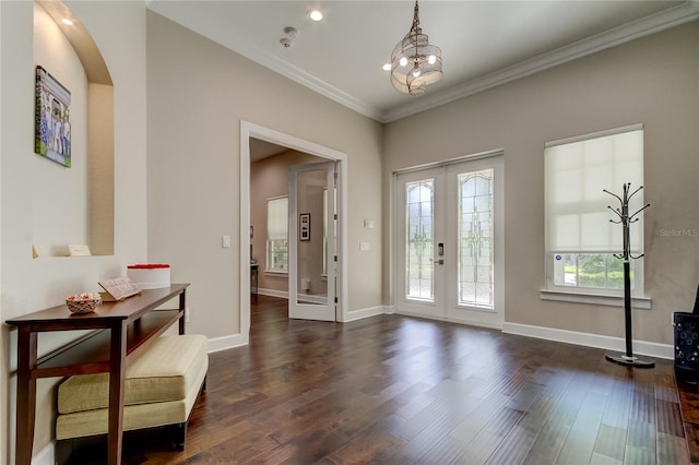 foyer with a chandelier, french doors, dark hardwood / wood-style flooring, and crown molding