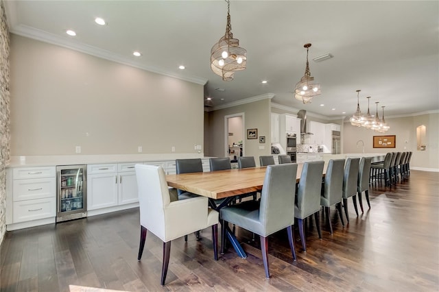 dining area with dark hardwood / wood-style flooring, crown molding, and wine cooler