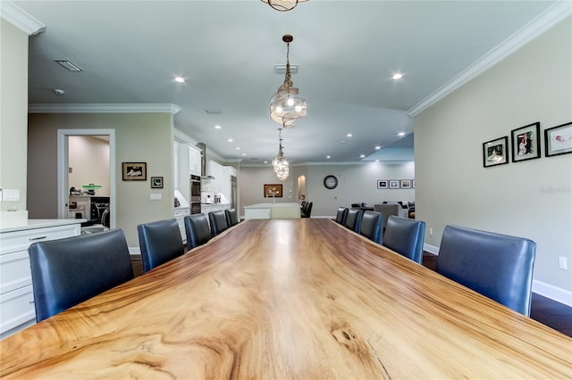 dining area featuring crown molding and hardwood / wood-style floors