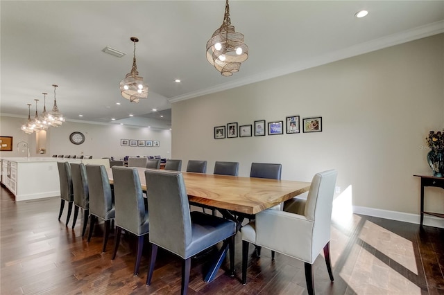 dining room with dark wood-type flooring and ornamental molding