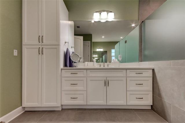 bathroom featuring tile patterned floors, vanity, and tile walls