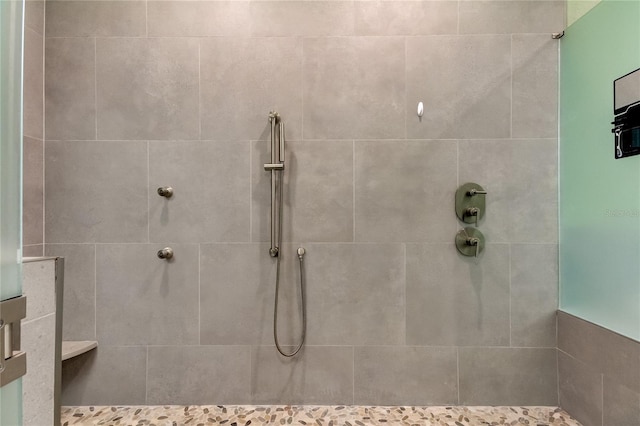 bathroom with tiled shower