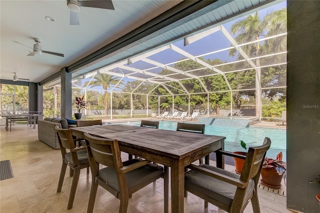 view of patio / terrace featuring ceiling fan and glass enclosure