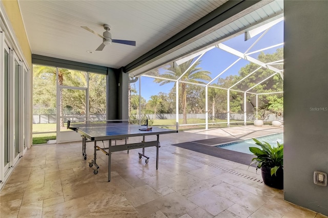 interior space with ceiling fan and a pool