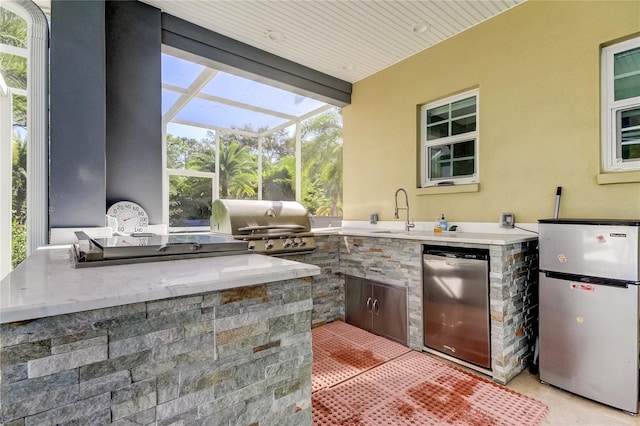 view of patio / terrace featuring area for grilling, sink, glass enclosure, and grilling area