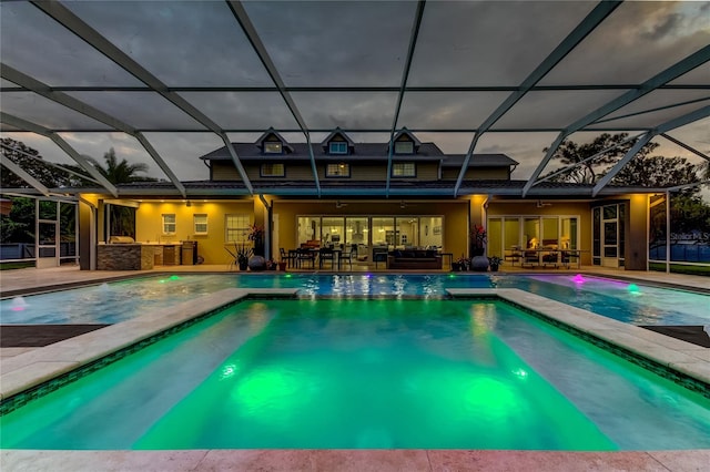 view of swimming pool featuring a lanai, an in ground hot tub, and a patio