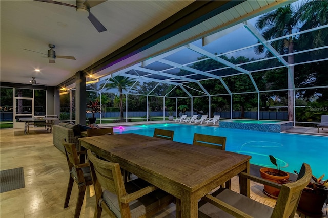 view of swimming pool featuring an in ground hot tub, glass enclosure, ceiling fan, and a patio area