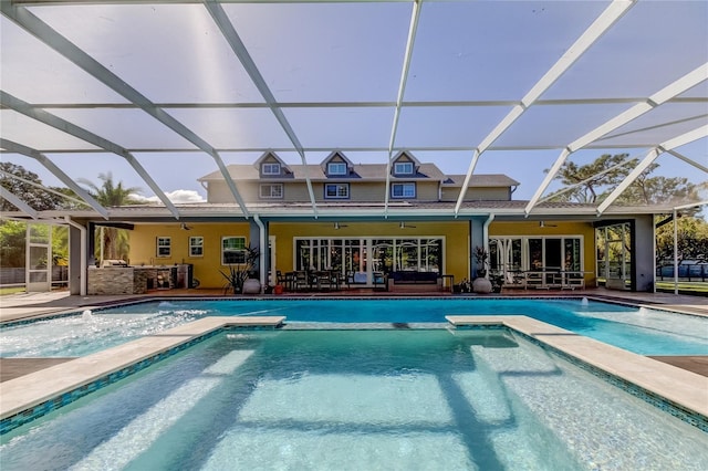 view of swimming pool featuring a lanai, a bar, ceiling fan, and a patio area