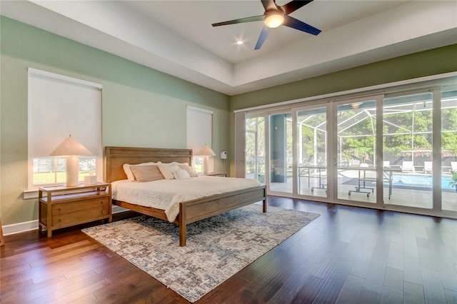 bedroom featuring access to outside, ceiling fan, and dark hardwood / wood-style flooring