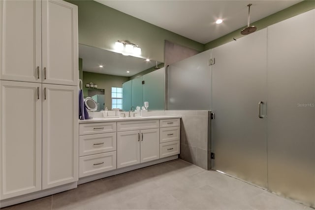 bathroom featuring vanity and a shower with door