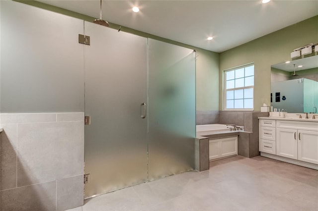 bathroom featuring vanity and separate shower and tub