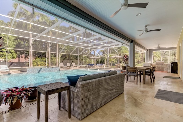 view of patio featuring ceiling fan, an outdoor kitchen, a lanai, a grill, and pool water feature