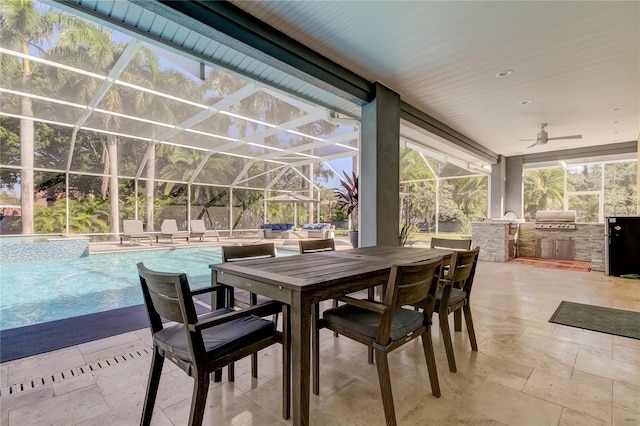 view of patio / terrace with grilling area, glass enclosure, and an outdoor kitchen