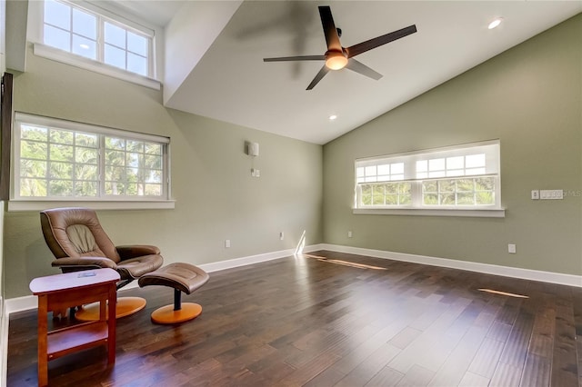 sitting room with ceiling fan, high vaulted ceiling, and dark wood-type flooring