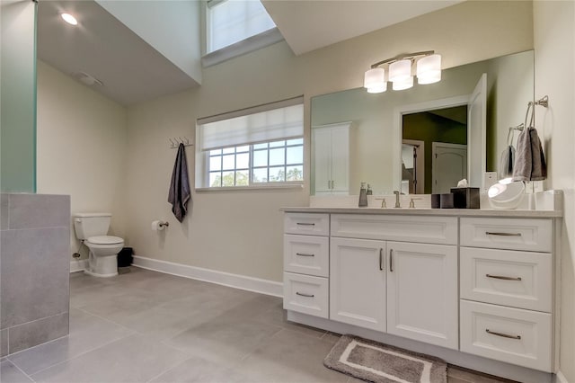 bathroom featuring tile patterned flooring, vanity, and toilet