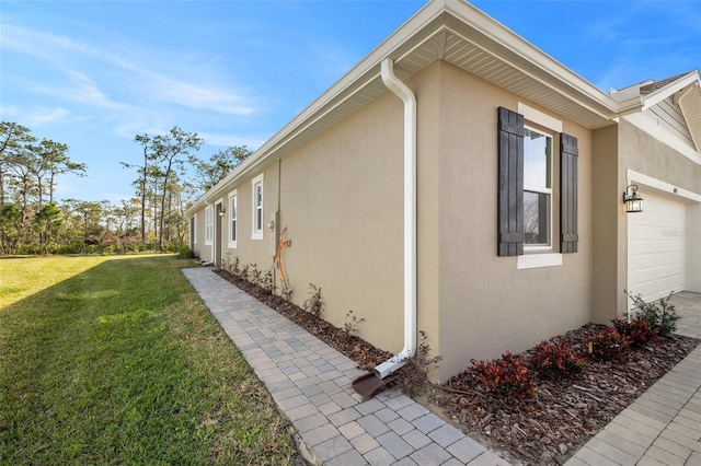 view of property exterior featuring a garage and a yard