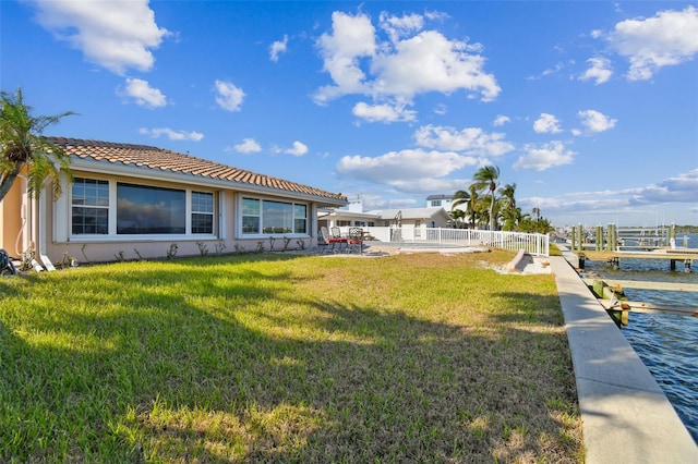 view of yard with a water view and a patio area