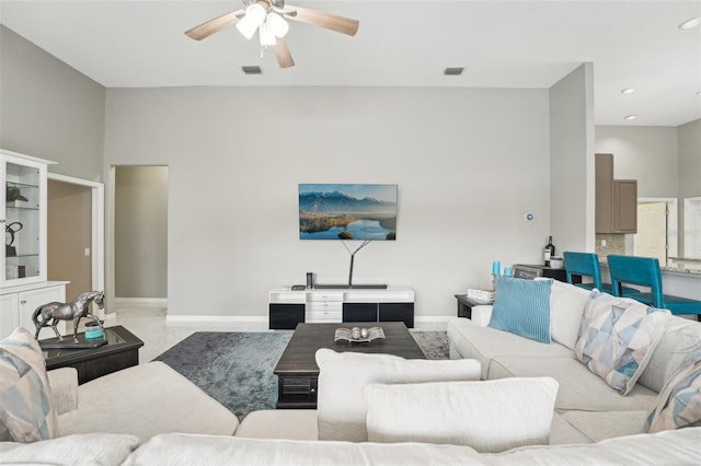 carpeted living room with ceiling fan