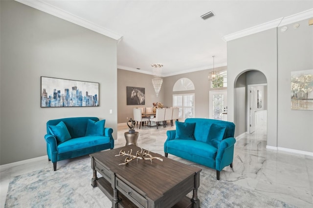 living room with an inviting chandelier and crown molding