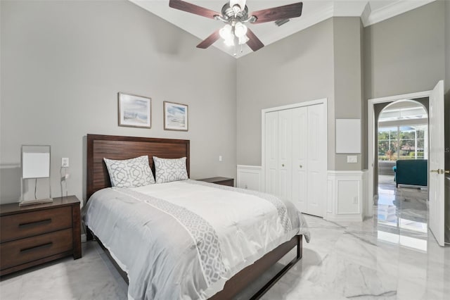 bedroom with high vaulted ceiling, ceiling fan, crown molding, and a closet