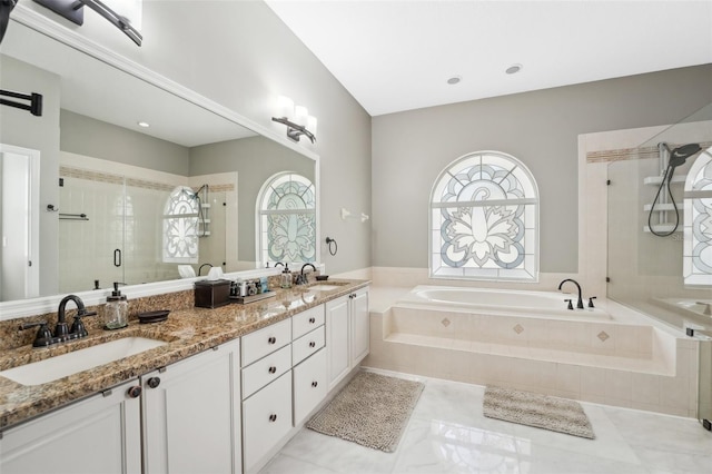 bathroom with a wealth of natural light, vanity, tile patterned floors, and separate shower and tub