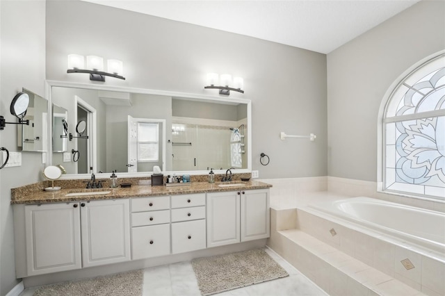 bathroom with tile patterned flooring, a wealth of natural light, vanity, and plus walk in shower