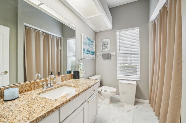 bathroom featuring toilet and vanity