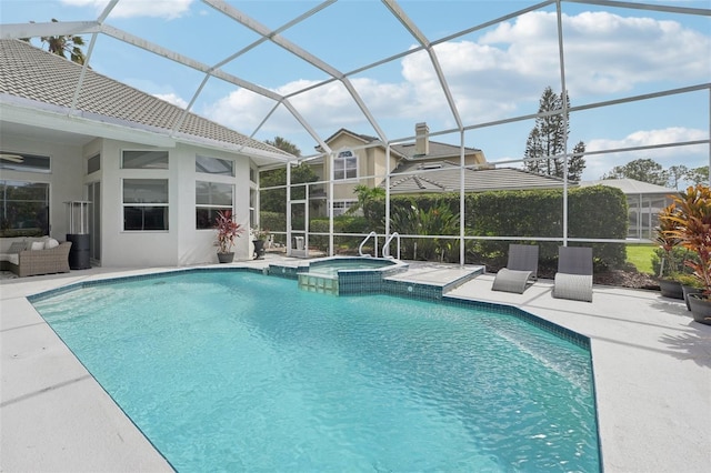 view of pool featuring a lanai, an in ground hot tub, and a patio area