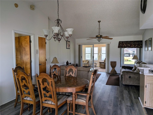 dining room with a wealth of natural light, lofted ceiling, dark hardwood / wood-style floors, and ceiling fan with notable chandelier