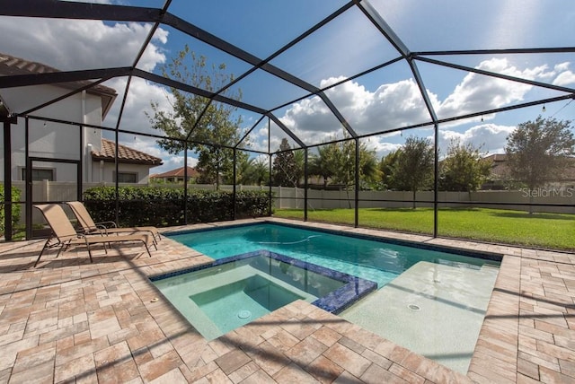 view of pool with a lanai, a patio area, an in ground hot tub, and a lawn