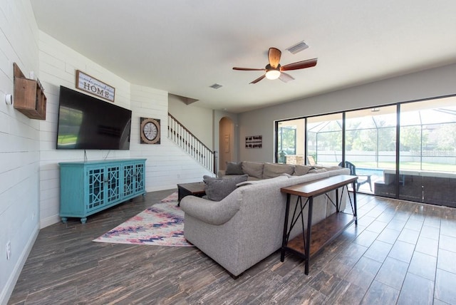 living room featuring dark hardwood / wood-style flooring and ceiling fan