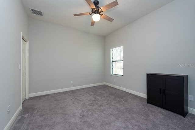 carpeted spare room with ceiling fan