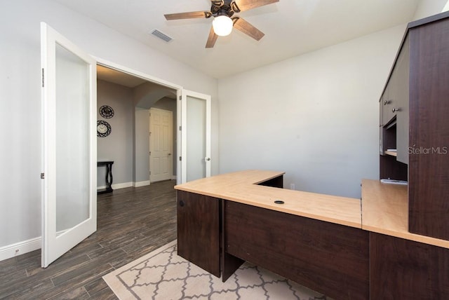 home office with ceiling fan and dark wood-type flooring