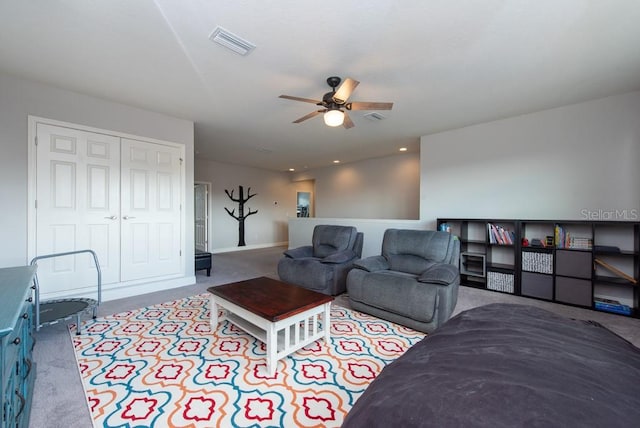 living room with ceiling fan and light colored carpet