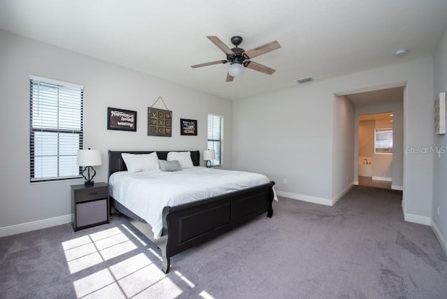 bedroom featuring carpet floors, ceiling fan, and connected bathroom